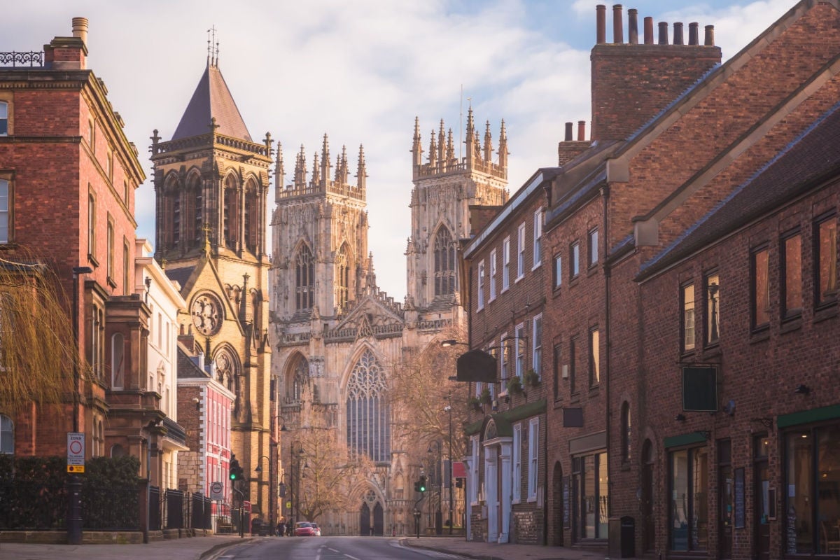 the historic old town of York along Museum St. looking towards York Minster Cathedral in Yorkshire, England, UK.